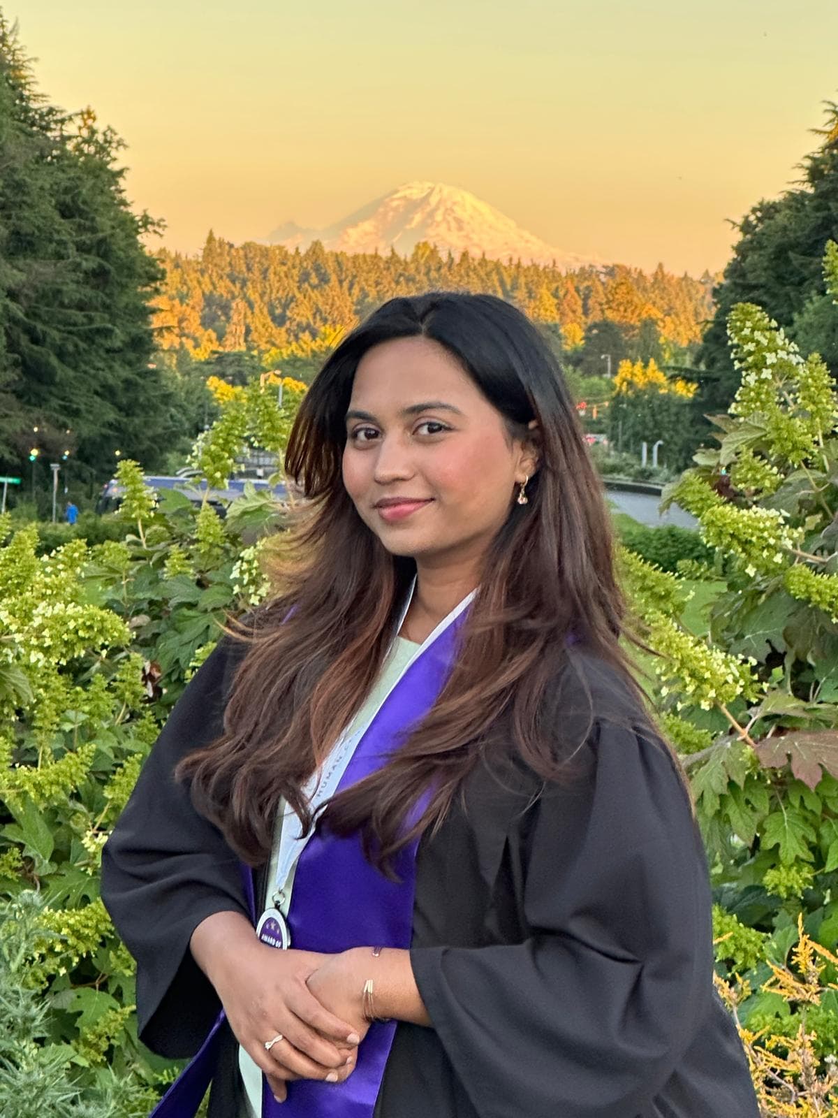 Reshma at graduation with Mt Rainier at sunset